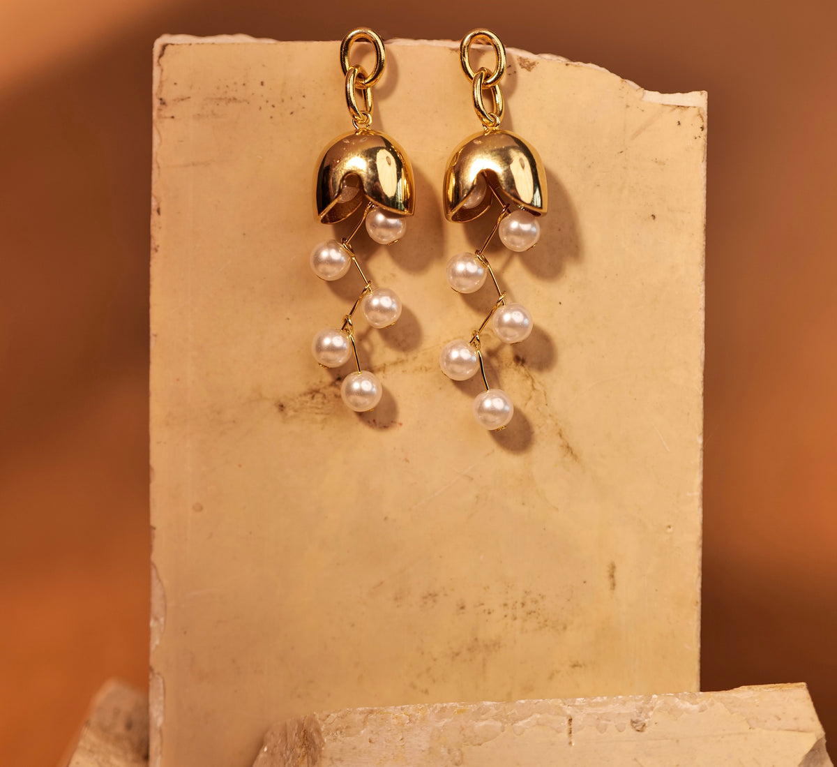 Bell Earrings with Pearl earrings by Nashira, shown close up