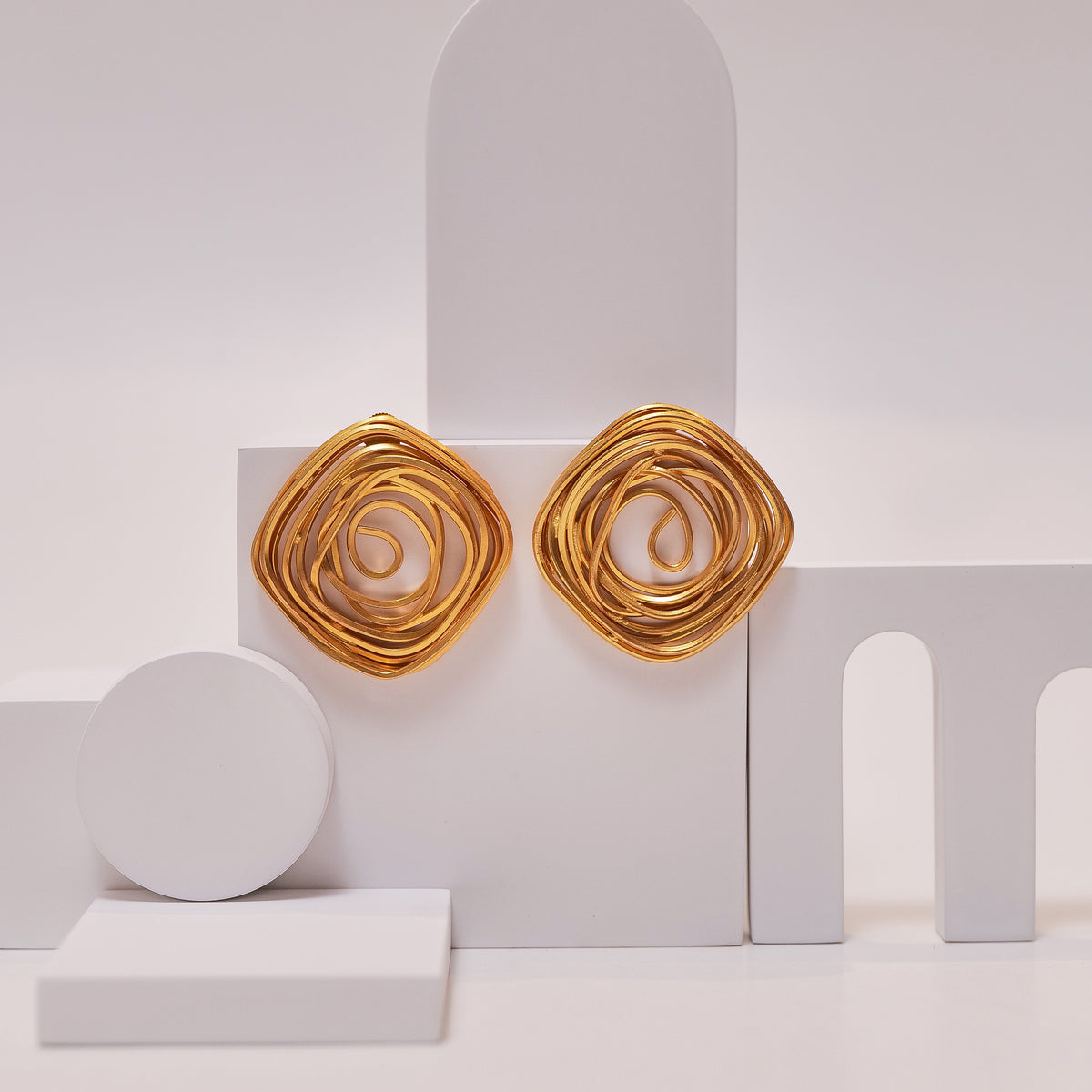 Spiral Rose Studs earrings by Nashira, shown close up
