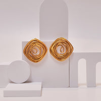 Spiral Rose Studs earrings by Nashira, shown close up
