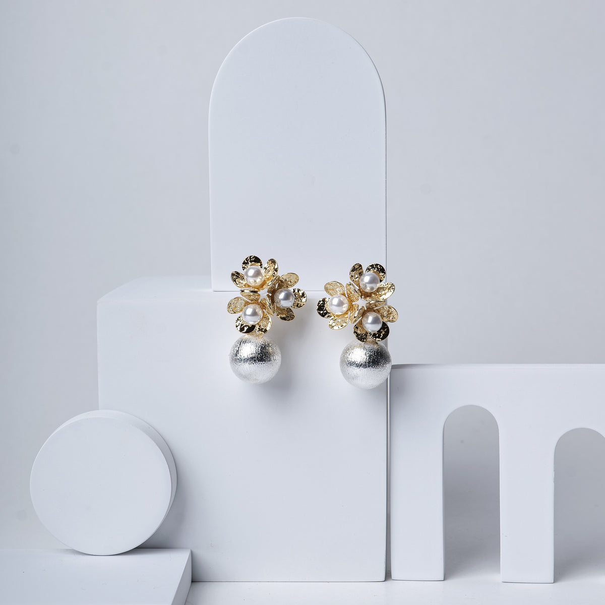 Triple Flower Cocktail Earrings earrings by Nashira, shown close up