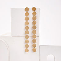 Coin Dangler earrings by Nashira, shown close up