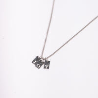 Dainty Alphabet String - Silver necklace by Nashira, shown close up