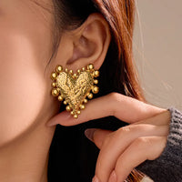 Love Bomb Studs earrings by Nashira, shown close up