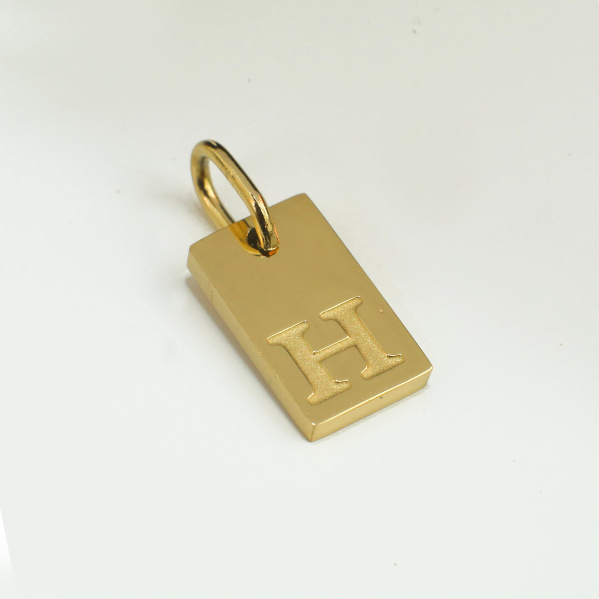 Dainty Alphabet Charm Gold  - H charm by Nashira, shown close up