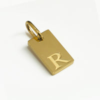 Dainty Alphabet Charm Gold  - R charm by Nashira, shown close up